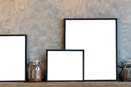 Mockup of photo frame and coffee in glass jar over the wooden shelves on Vintage wall background. Product presentation with interior conceptの写真素材