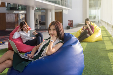 three women using social network each technology equipment In the modern creative Office, business social network conceptの写真素材