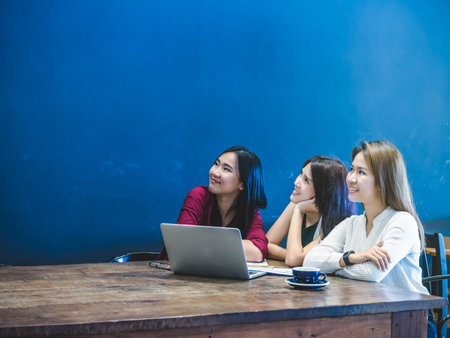 Group Of Asian Businesswomen with casual suit brainstorm Meeting and looking for the vision and...