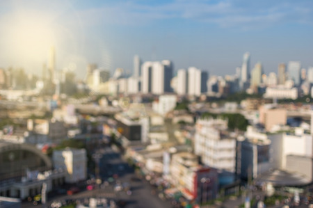 abstract Blurred photo of cityscape with lens flare background, blur backgrounds conceptの写真素材