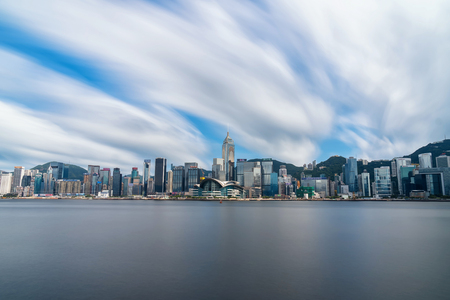 HONGKONG - JULY 09 : Scene of Hong Kong Cityscape river side in the afternoon with smooth cloud at Victoria harbour on 09 july, 2017 HongKong, presented the modern construction concept