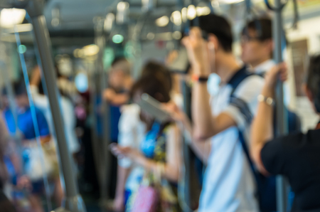 Abstract blurred photo of passengers who are using the smart phone or tablet in sky train, transportation and connection conceptの写真素材