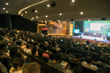 Abstract blurred photo of conference hall or seminar room with attende background in with low light situation, business and education conceptのeditorial素材