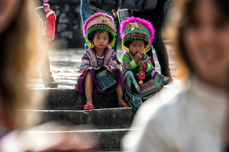 SAPA, VIETNAM - SEP 23 : Unidentified cute girl of the flower H'mong indigenous women at walking street on September 23, 2017 in Sapa, Vietnam.Flower H'mong tribes is one of the minority tribes in Sapa.のeditorial素材