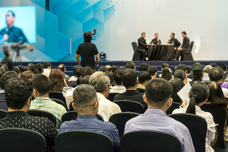 Speakers on the stage with Rear view of Audience in the conference hall or seminar meeting, business and education about investment conceptのeditorial素材