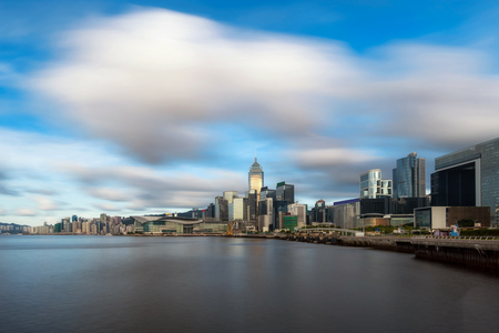 Scene of Hong Kong Cityscape river side in the afternoon with smooth cloud at Victoria harbour, HongKong, presented the modern construction conceptの写真素材