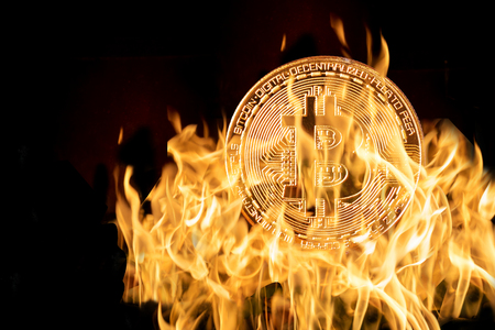 Bitcoin mockup in fire over the dark black background, Block chain technology of Crypto concept, Business and investoment concept, high riskの写真素材