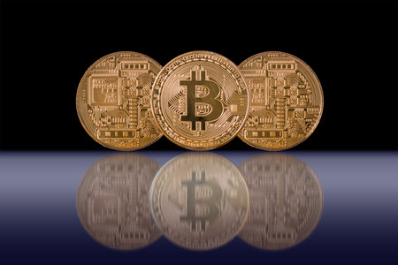 Closeup three Bitcoins mockup with reflection on black color background, cryptocurrency and isolate...