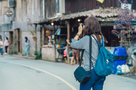 Backside of Asian traveler taking the photo in mae kam pong village, chiang mai, thailand, travel and lifestyle conceptの写真素材