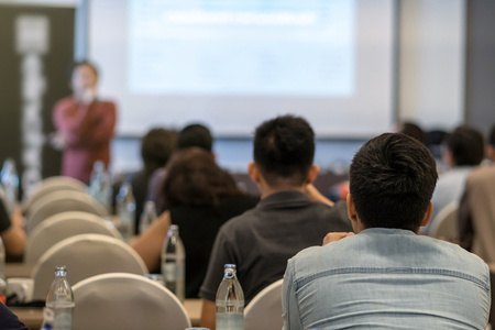 Rear view of audience listening the specker in front of the meeting room or seminar room, business seminar and education conceptの写真素材