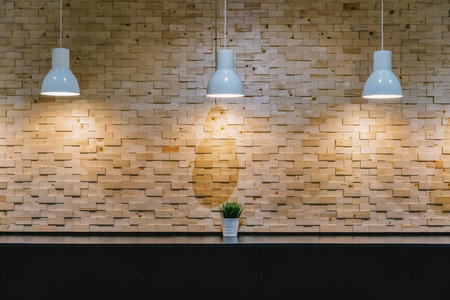 Mockup of the Light over the cafe interior bar table beside the wall with wooden styleの写真素材