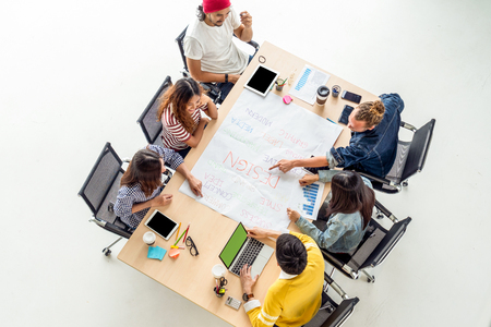 Top view scene of Asian and Multiethnic Business people with casual suit working with brainstorming and pointing to the design concept in the modern workplace, people business group conceptの写真素材