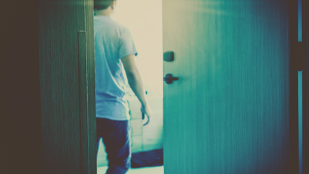 Motion blurred scene of hand man open the door into his hotel room after using an electronic security key card, holiday and leisure conceptの写真素材