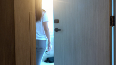 Motion blurred scene of hand woman open the door into her hotel room after using an electronic security key card, holiday and leisure conceptの写真素材