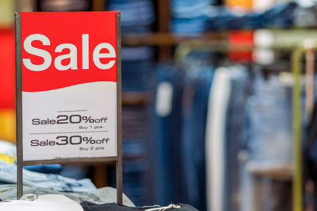 sale mock up advertise display frame setting over the stack of jeans and clothes line in the...