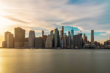 New york Cityscape with Brooklyn Bridge over the east river at the evening time, USA downtown skyline, United states of America, Architecture and building with tourist conceptの写真素材