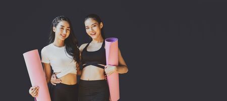 Banner and cover of Portrait Couple sporty asian woman standing and smiling, wearing sportswear bra and pants fashion, posture position, sport club community, sports and healthcare conceptの写真素材