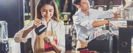 Banner of Asian Barista preparing cup of coffee, espresso with latte or cappuccino for customer order in coffee shop,bartender pouring milk,Small business owner and startup in coffee shop conceptの写真素材