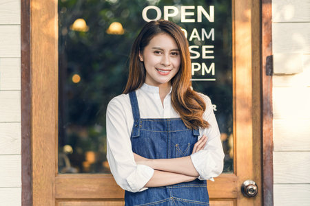 Portrait Asian Small business owner doing Hands crossed for Welcome Open in front of coffee shop, startup with cafe store, installing open and close label conceptの写真素材