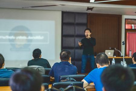 Rear view of Audience listening Speakers on the stage in the conference hall or seminar meeting, business and education about investment conceptの写真素材