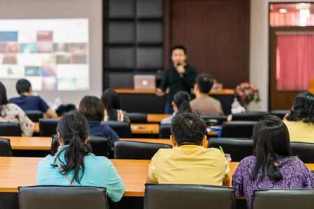 Rear view of Audience listening Speakers on the stage in the conference hall or seminar meeting, business and education about investment conceptの写真素材