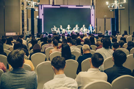 Rear view of Asian audience joining and listening group of speaker talking on the stage in the seminar meeting room or conference hall, business and education, associate and startup business conceptのeditorial素材