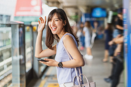 Asian woman at train station platformの写真素材