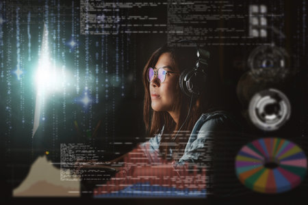 Asian Businesswoman working hard with front of computer desktop with programming source code and motion graphic over computer screen in work place at late times with exciting and serious actionの写真素材