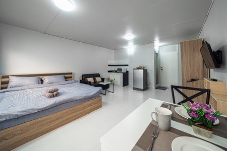 Luxury Interior living room with sofa bed and bed queen size, Dining table,air conditioner, and furniture, Studio room type of condominium or apartment, service apartment and Accommodations Conceptの写真素材
