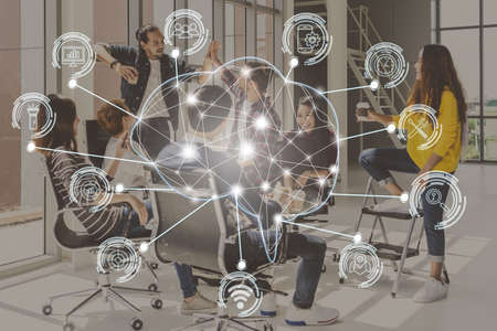 Polygonal brain shape of an artificial intelligence with various icon of smart city Internet of Things over group of diverse Business people are brainstorming and hand shakingの写真素材