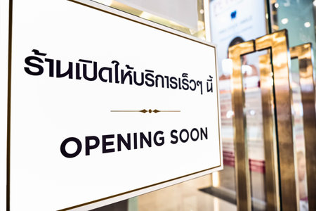 New normal Concept, OPENING SOON text with thai language with the same meaning on the Billboard in front of beauty and spa in department storeの写真素材