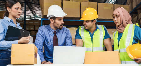 Banner Group of Diversity warehouse worker meeting and brainstorming together in local warehouse, muslim with Hijab, indian, white caucasian and asian people wearing safety clothes in industry conceptの写真素材