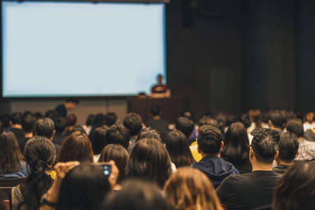 Rear view of Asian audience joining and listening speaker talking on the stage in the seminar meeting room or conference hall, education and workshop, associate and startup business conceptの写真素材