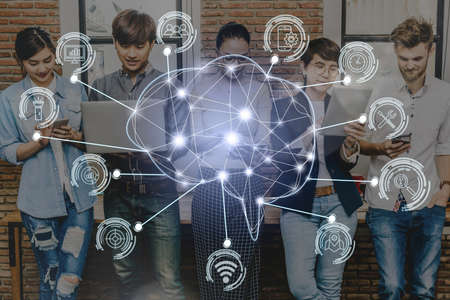 Polygonal brain shape of an artificial intelligence with various icon of smart city Internet of Things Technology over Group Of Multiethnic people using social network, AI and business IOT conceptの写真素材