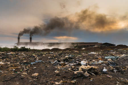 Garbage in front of Smokestack Factory, industry and pollution conceptの写真素材