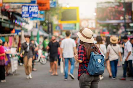 Back side of Young Asian traveling women walking and looking in Khaosan Road walking street in...