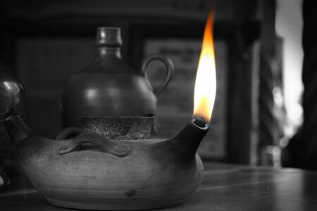 Burning flame in a vintage lamp in black and white の写真素材
