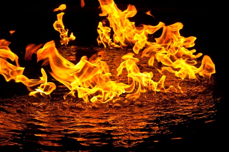 Fire flames reflected in waterの写真素材