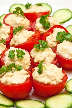 filled tomato appetizer on a plateの写真素材