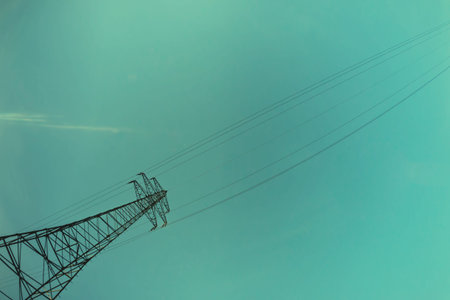 Energy concept with power lines against blue skyの写真素材