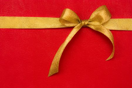 golden gift ribbon and bow on red background. some other you may also likeの写真素材