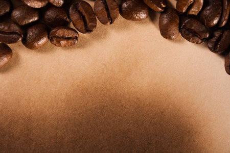 coffee beans on old burnt paper background