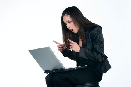 young pretty business woman working on laptop very emotional - isolated on white backgroundの写真素材