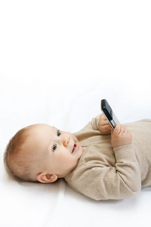 cute baby boy playing with mobile phone on white - closeupの写真素材