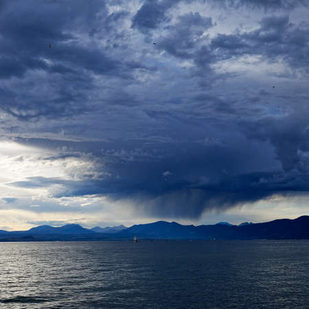 Clouds full of rain coming to Cisano by Garda Lake Italyの写真素材