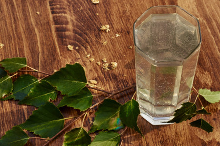 Glasses of birch sap juice birch branches on wooden table background. Healthy and vitamin food spring useful vitamin nutrition fresh drink.の写真素材