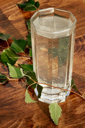 Glasses of birch sap juice birch branches on wooden table background. Healthy and vitamin food spring useful vitamin nutrition fresh drink.の写真素材