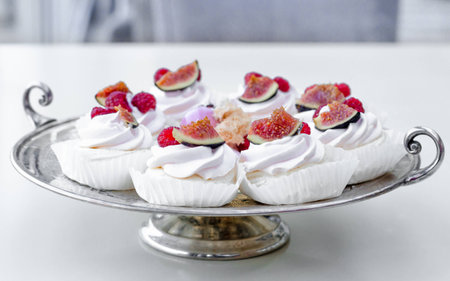 Candy Bar. Delicious homemade dessert meringue with figs and raspberries for christmas or new year on silver plate.の写真素材