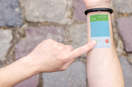 Wearable Projection Bracelet Smartphone Mobile Phone on Man Hand Invisible Tech technology Innovations Future Concept Bussines. Technological Progress Communication. Incoming call.の写真素材