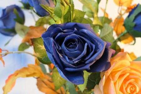 A wonderful bouquet of bright artificial flowers and leaves.の写真素材